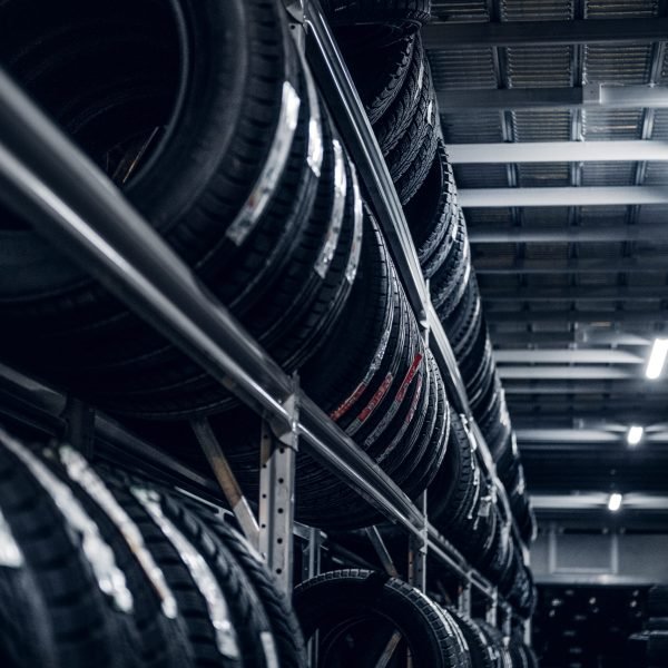 Dark storage full or big variety of new tyres at busy warehouse.